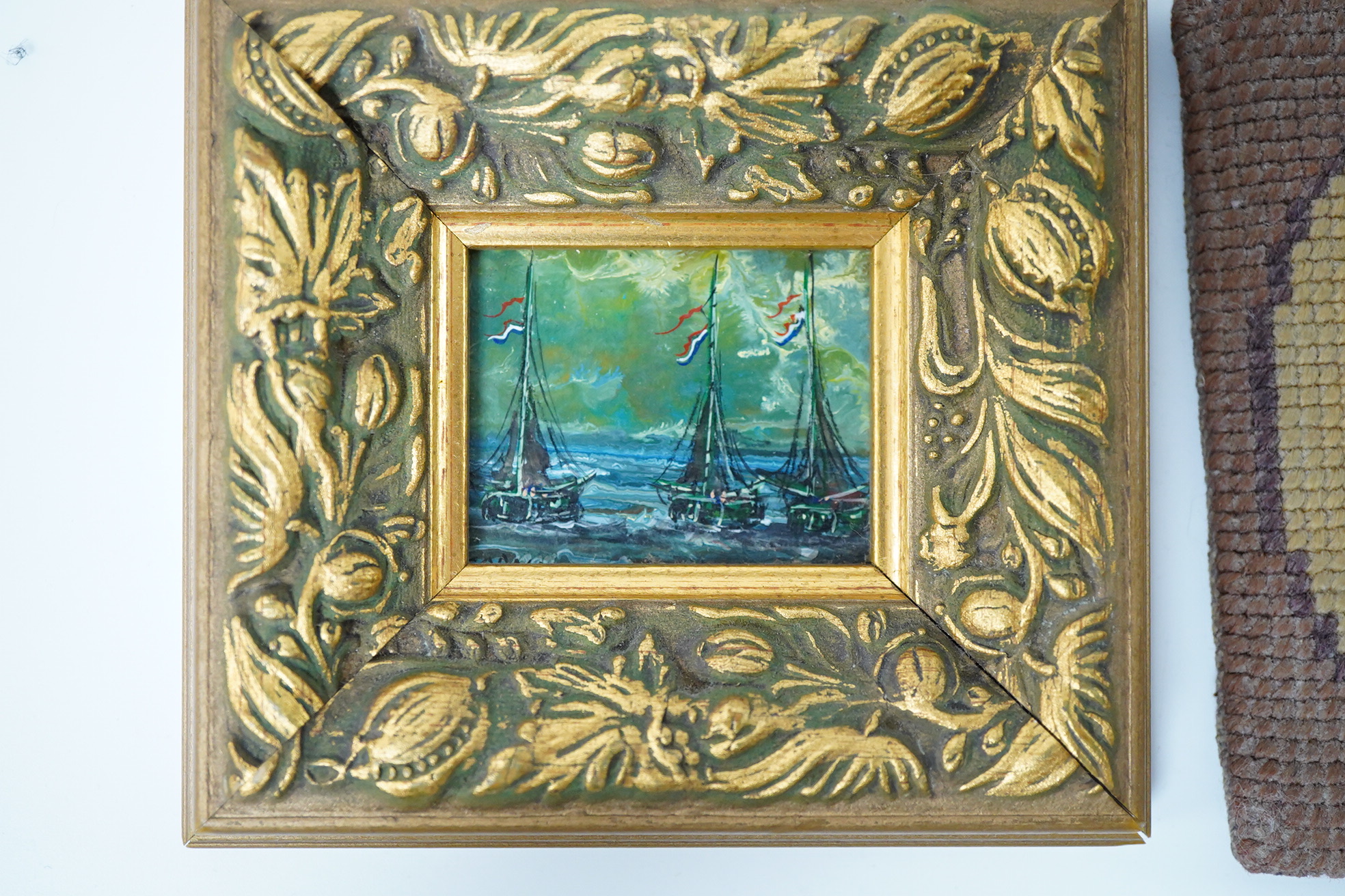 A small group of various collectables including an Edwardian oil on canvas board, study of a dog, a 19th century woolwork, cast iron bottle opener in the form of a parrot and an Art Deco bookend surmounted with a cat